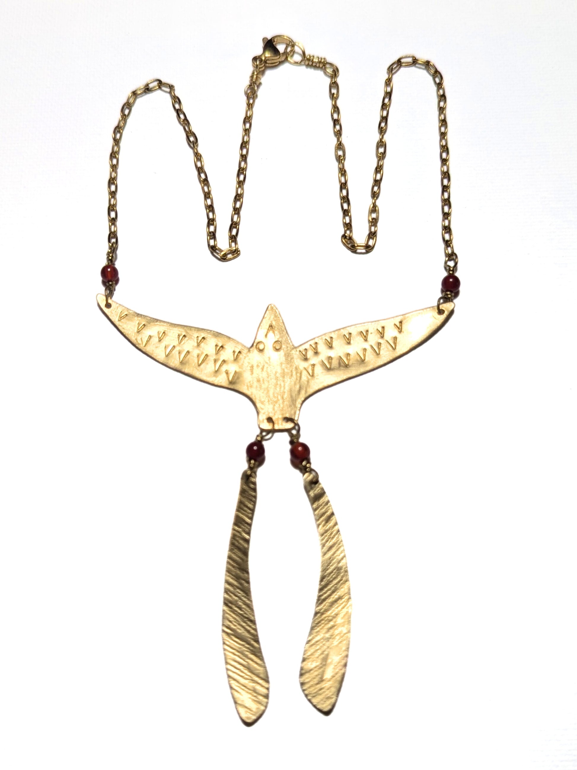 Gold necklace with a unique hammered metal phoenix pendant